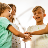 Children making a deal outdoors